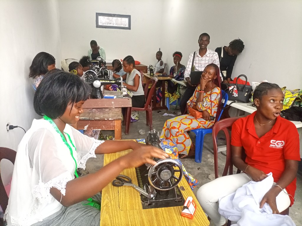 Participants learning sewing skills in a vocational business training workshop