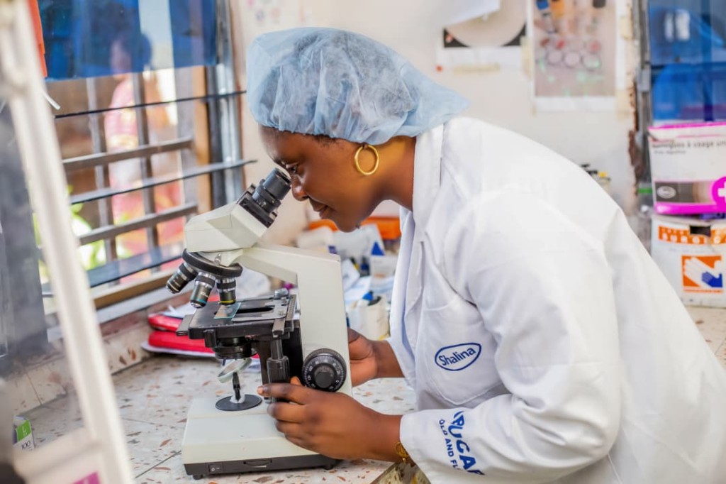 Laboratory technician using a microscope